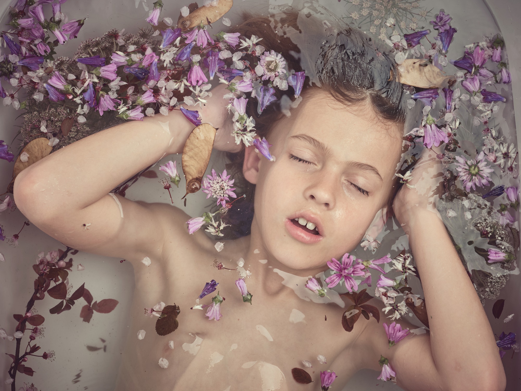 Boy in bathtub with flowers